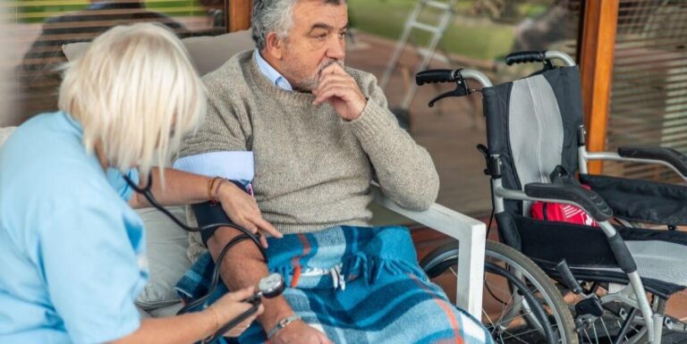 Female Nurse Checking Blood Pressure of Elderly at Assisted Living Facility