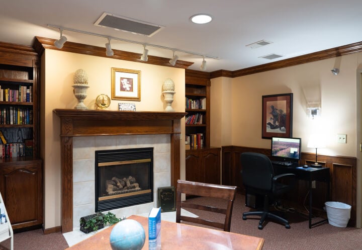 Cozy Library with a Fireplace and Computer at an Assisted Living Community Cozy Library with a Fireplace and Computer at an Assisted Living Community
