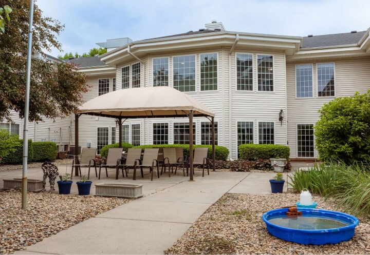 Shaded Outdoor Patio with Lounge Seating at an Assisted Living Community Shaded Outdoor Patio with Lounge Seating at an Assisted Living Community