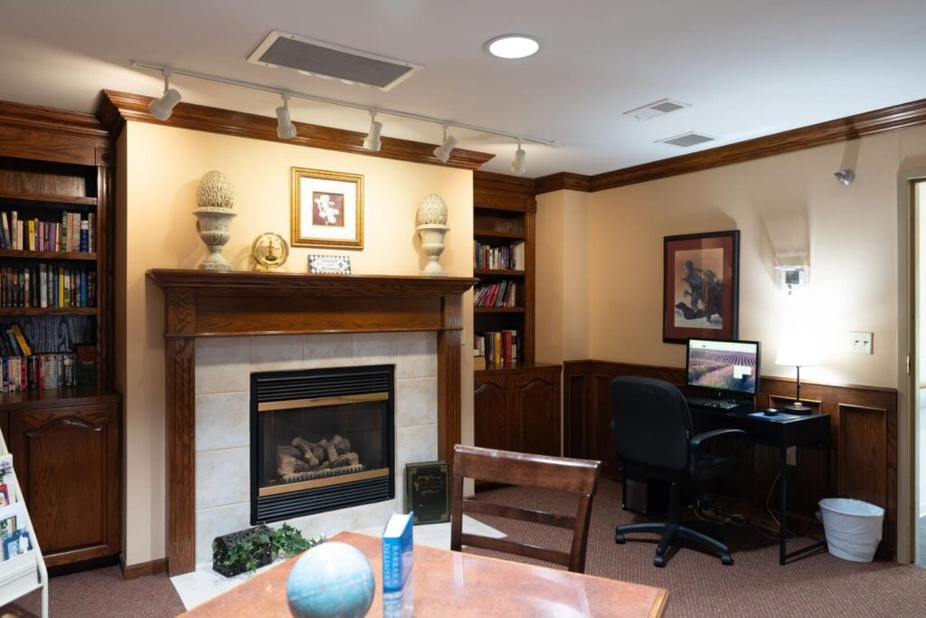 Library with a Fireplace and Computer Station at an Assisted Living Community
